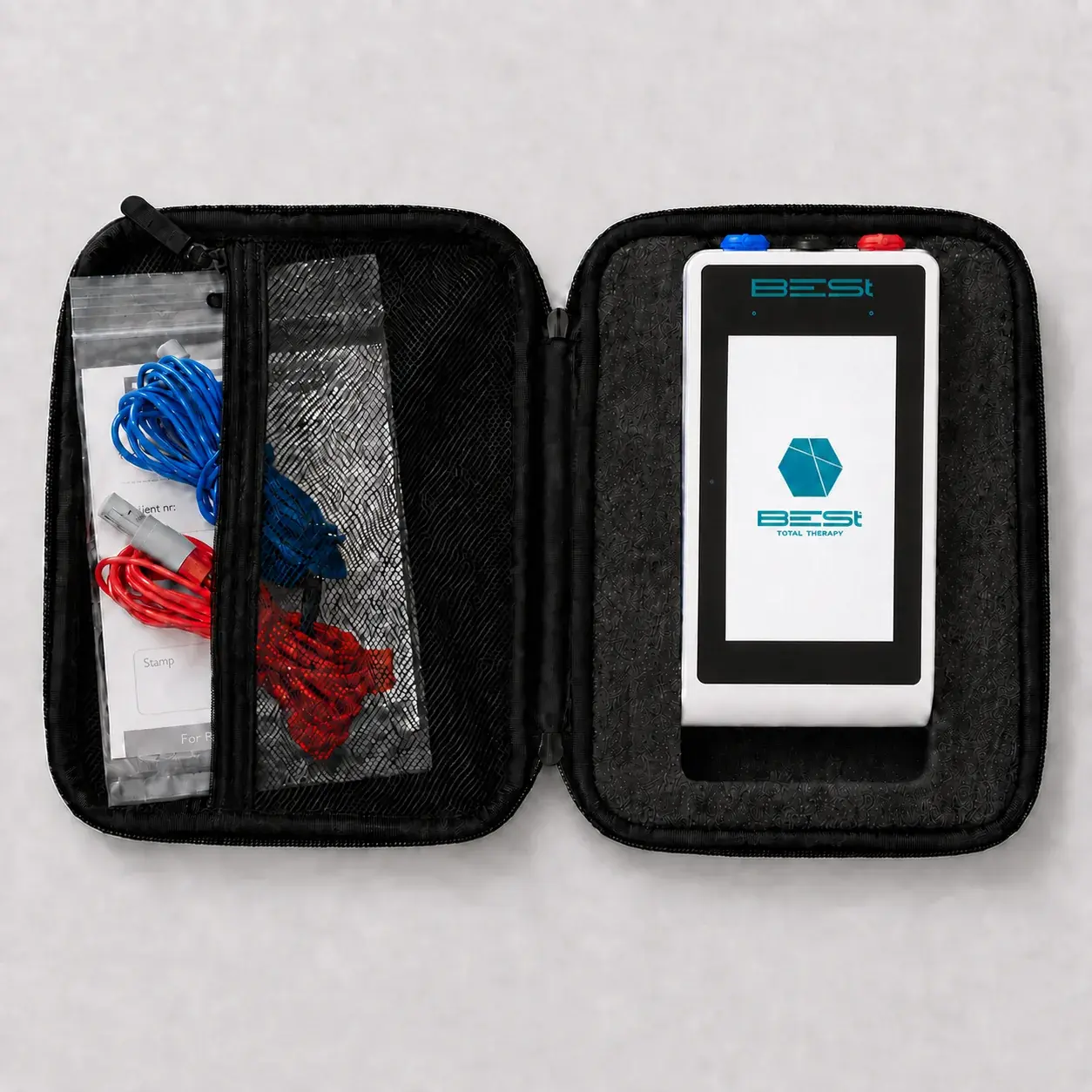 The open case from above: the device seated in the lid, the cables bagged in the mesh pocket